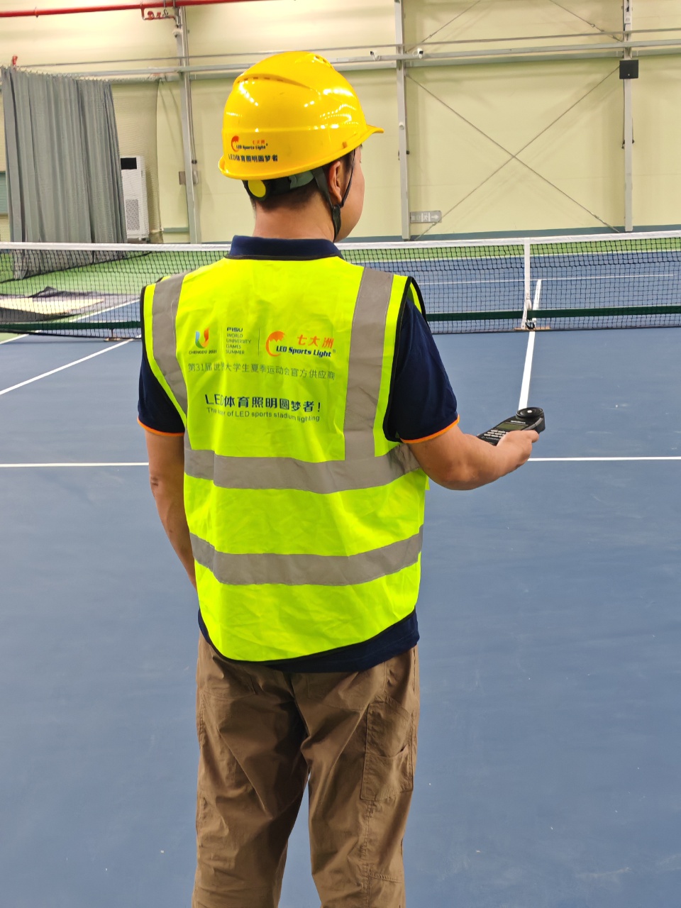 Technician inspecting a sports court at Wutaizha Stadium